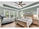 Spacious main bedroom featuring a trey ceiling, ceiling fan and large windows at 1115 Old Field Dr, Summerville, SC 29483