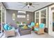Screened porch with wicker furniture, ceiling fan, and coastal accents for relaxing outdoors at 1115 Old Field Dr, Summerville, SC 29483