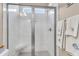 Modern glass shower with white tile, a built-in bench, and coastal-inspired towels at 1115 Old Field Dr, Summerville, SC 29483