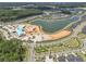 An aerial shot shows a community with a lake, mini golf, a playground under construction, and residential houses at 1136 Kane Blue, Summerville, SC 29485