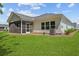 Bright backyard showing the screened porch, windows, and A/C unit of this home at 1136 Kane Blue, Summerville, SC 29485