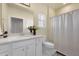 Bright bathroom featuring white vanity, quartz countertops, decorative mirror, shower and toilet at 1136 Kane Blue, Summerville, SC 29485