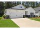 Bright home exterior with stone facade, two car garage, and well manicured lawn at 1136 Kane Blue, Summerville, SC 29485
