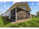 Screened-in porch attached to home's back exterior with beautiful lawn and landscaping at 1136 Kane Blue, Summerville, SC 29485