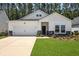 Charming one-story home featuring a well-manicured lawn and a two-car garage at 1136 Kane Blue, Summerville, SC 29485