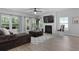 Sunlit living room with fireplace, large windows, and comfortable seating provides a relaxing space at 1136 Kane Blue, Summerville, SC 29485