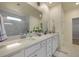 A bright main bathroom featuring double sinks, white cabinetry, and a large mirror at 1136 Kane Blue, Summerville, SC 29485
