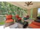 Inviting screened porch with comfortable outdoor seating, overhead fan and wooded backyard view at 1136 Kane Blue, Summerville, SC 29485