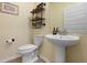 Stylish powder room with a pedestal sink, decorative shelving, and modern fixtures at 1136 Kane Blue, Summerville, SC 29485