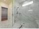 Main bathroom shower featuring marble look tiling, glass enclosure, and bench seat at 1136 Kane Blue, Summerville, SC 29485