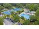 Aerial view of community pool and tennis courts surrounded by lush greenery at 114 Marshside Dr, Summerville, SC 29485