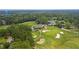 Expansive aerial view of golf course with water tower in the distance, surrounded by trees at 114 Marshside Dr, Summerville, SC 29485