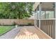 Back porch with wood flooring, screened posts, and a view of the private fenced backyard at 114 Marshside Dr, Summerville, SC 29485