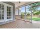 Back porch with wood flooring, white posts, and access to the back yard at 114 Marshside Dr, Summerville, SC 29485