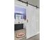 Charming bathroom with black vanity, illuminated mirror, and sliding barn door at 114 Marshside Dr, Summerville, SC 29485