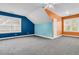 Spacious bedroom with unique blue and orange accent walls and carpet flooring at 114 Marshside Dr, Summerville, SC 29485