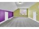 Unfinished bonus room with vaulted ceiling, gray carpet, and colorful walls with window at 114 Marshside Dr, Summerville, SC 29485