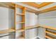 Spacious walk-in closet with custom wood shelving and hanging rods for organization at 114 Marshside Dr, Summerville, SC 29485