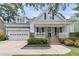 Inviting two-story home with a charming front porch, attached garage, and meticulous landscaping at 114 Marshside Dr, Summerville, SC 29485