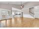 Open-concept living space with hardwood floors, stairs, and kitchen access at 114 Marshside Dr, Summerville, SC 29485