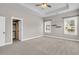 Spacious primary bedroom with tray ceilings, carpet floors, and ensuite bathroom at 114 Marshside Dr, Summerville, SC 29485