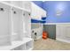 Well-organized mudroom featuring a white cubby system, cabinets, and tile flooring at 114 Marshside Dr, Summerville, SC 29485