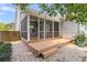 A screened-in porch with wood floors, white trim, and a ceiling fan for outdoor relaxation at 114 Marshside Dr, Summerville, SC 29485