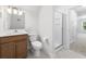 Modern bathroom with wood vanity, tile floor, a toilet and glass shower door at 1150 Oak Bluff Ave, Charleston, SC 29492