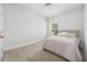 Bright bedroom features a window, carpet and comfortable bed with stylish bedding at 1150 Oak Bluff Ave, Charleston, SC 29492