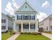 Charming two-story home with a welcoming front porch and well-manicured lawn at 1150 Oak Bluff Ave, Charleston, SC 29492