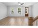 Inviting living room with hardwood floors, ceiling fan, and natural light from a doorway and windows at 1150 Oak Bluff Ave, Charleston, SC 29492