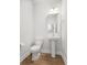 Half bathroom featuring pedestal sink, toilet, and decorative mirror at 1150 Oak Bluff Ave, Charleston, SC 29492