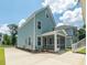 Backyard view showcasing a screened porch and convenient driveway access at 1150 Oak Bluff Ave, Charleston, SC 29492