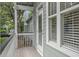 Cozy back porch features natural light with windows and a door to the backyard at 116 Cartright St, Daniel Island, SC 29492