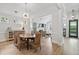 Sunlit dining area with hardwood floors, chandelier and seating for six at 116 Cartright St, Daniel Island, SC 29492