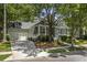 Inviting single-story home with mature trees, front porch and a two-car garage at 116 Cartright St, Daniel Island, SC 29492