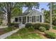 Charming single-story home features a manicured lawn, landscaped garden, and inviting front porch at 116 Cartright St, Daniel Island, SC 29492