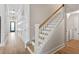 Inviting hallway featuring wood floors, white trim, and staircase leading to upper level at 116 Cartright St, Daniel Island, SC 29492