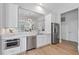 Bright kitchen features stainless steel appliances, white cabinets, and natural light at 116 Cartright St, Daniel Island, SC 29492