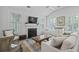 Bright living room with fireplace, wood floors and built-in cabinets at 116 Cartright St, Daniel Island, SC 29492