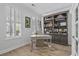 Charming home office space with custom bookcase and sunlit window, creating a great workspace at 116 Cartright St, Daniel Island, SC 29492