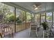 Screened-in porch provides lots of light and has comfortable seating at 116 Cartright St, Daniel Island, SC 29492