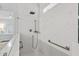 Bright bathroom shower featuring marble tile surround, with handheld sprayer and glass partition at 116 Cartright St, Daniel Island, SC 29492