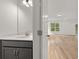 Bathroom with white countertops, gray cabinets, and view into living area at 117 Palfrey Dr, Ridgeville, SC 29472