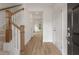 Inviting entryway with wood flooring and staircase with wooden banister at 117 Palfrey Dr, Ridgeville, SC 29472