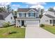 Charming two-story home with a two-car garage and well-manicured lawn at 117 Palfrey Dr, Ridgeville, SC 29472