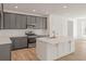 Modern kitchen featuring gray cabinets, stainless steel appliances, and a white countertop island at 117 Palfrey Dr, Ridgeville, SC 29472