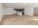 Open-concept living area with white walls, hardwood floors, and modern lighting at 117 Palfrey Dr, Ridgeville, SC 29472