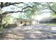 A spacious backyard with plenty of shade from mature trees and fencing on two sides at 1203 Hawthorne Rd, Hanahan, SC 29410