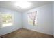 Cozy bedroom featuring light blue walls, carpeted flooring, and natural light from two windows at 1203 Hawthorne Rd, Hanahan, SC 29410
